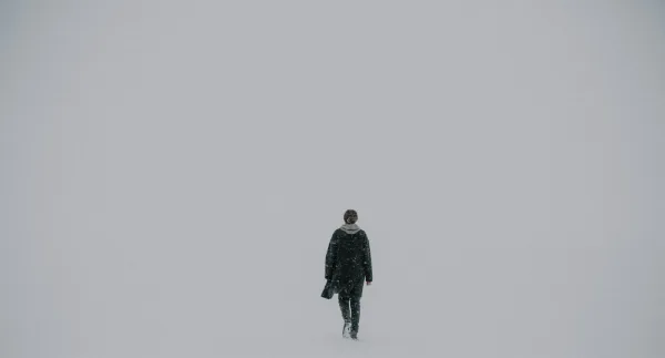 man walking on white surface